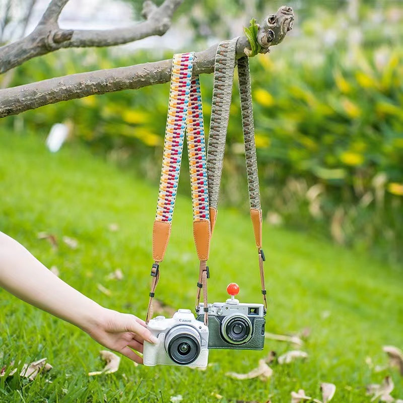 Assorted colors of vintage-inspired cotton and faux leather camera straps - including Brown, Pink, Yellow, Yellow Green, Blue, Grey-Green, White, and Rose