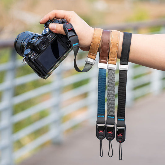 Assorted colors of wrist straps for cameras - including Black, Dark Green, Gray, and Blue